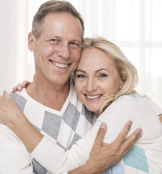 medium-shot-happy-couple-hugging-indoors